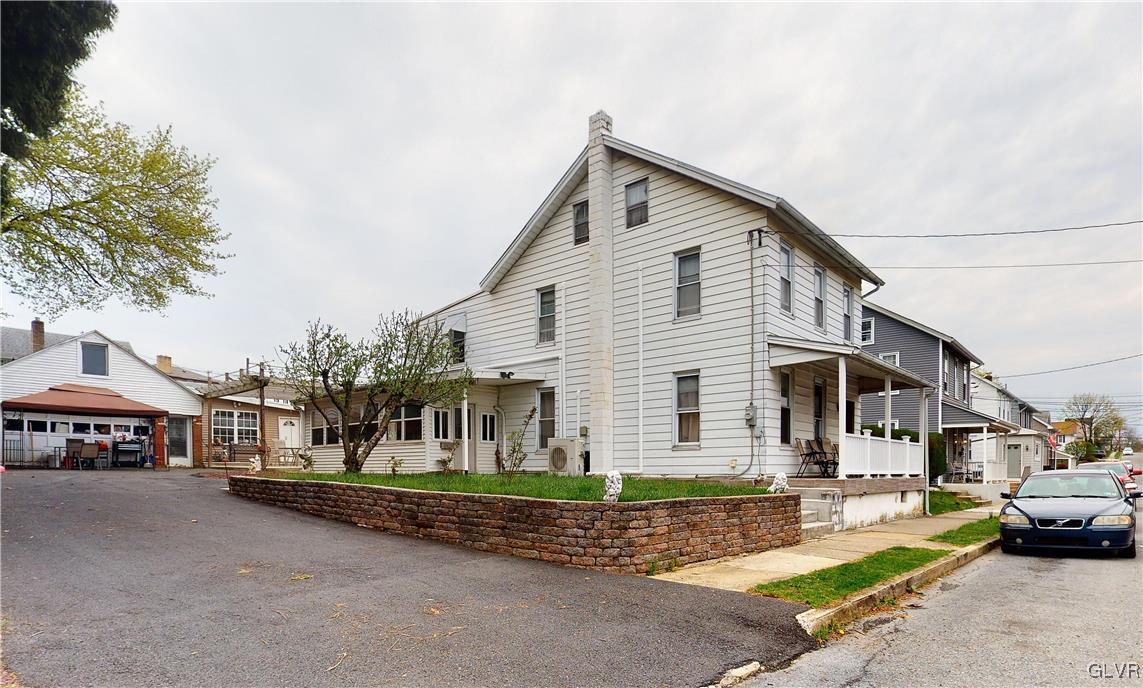 712 2nd Street Catasauqua, PA 18032 - Photo 2 of 36 a front view of a house with a garden and parking