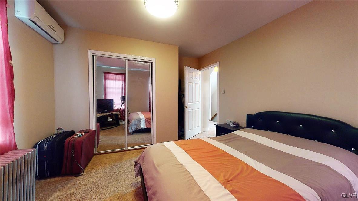 712 2nd Street Catasauqua, PA 18032 - Photo 24 of 36 a bedroom with a bed and a large mirror