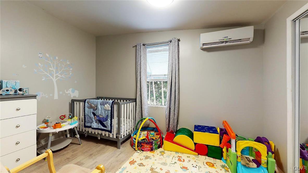 712 2nd Street Catasauqua, PA 18032 - Photo 27 of 36 a bedroom with baby bed and a dresser