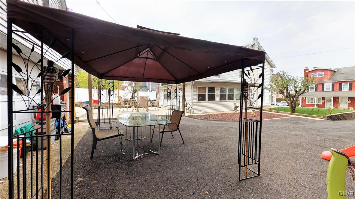 712 2nd Street Catasauqua, PA 18032 - Photo 29 of 36 a view of a patio with table and chairs under an umbrella