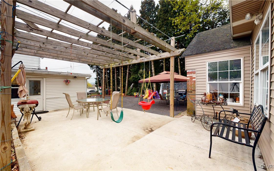 712 2nd Street Catasauqua, PA 18032 - Photo 31 of 36 a view of a patio with table and chairs under an umbrella with a barbeque