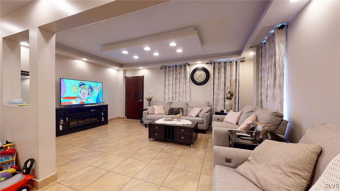712 2nd Street Catasauqua, PA 18032 - Photo 6 of 36 a living room with furniture and a flat screen tv