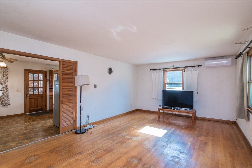 8 Sunset Drive Montague, MA 01376 - Photo 15 of 29 a view of an empty room with wooden floor and a window