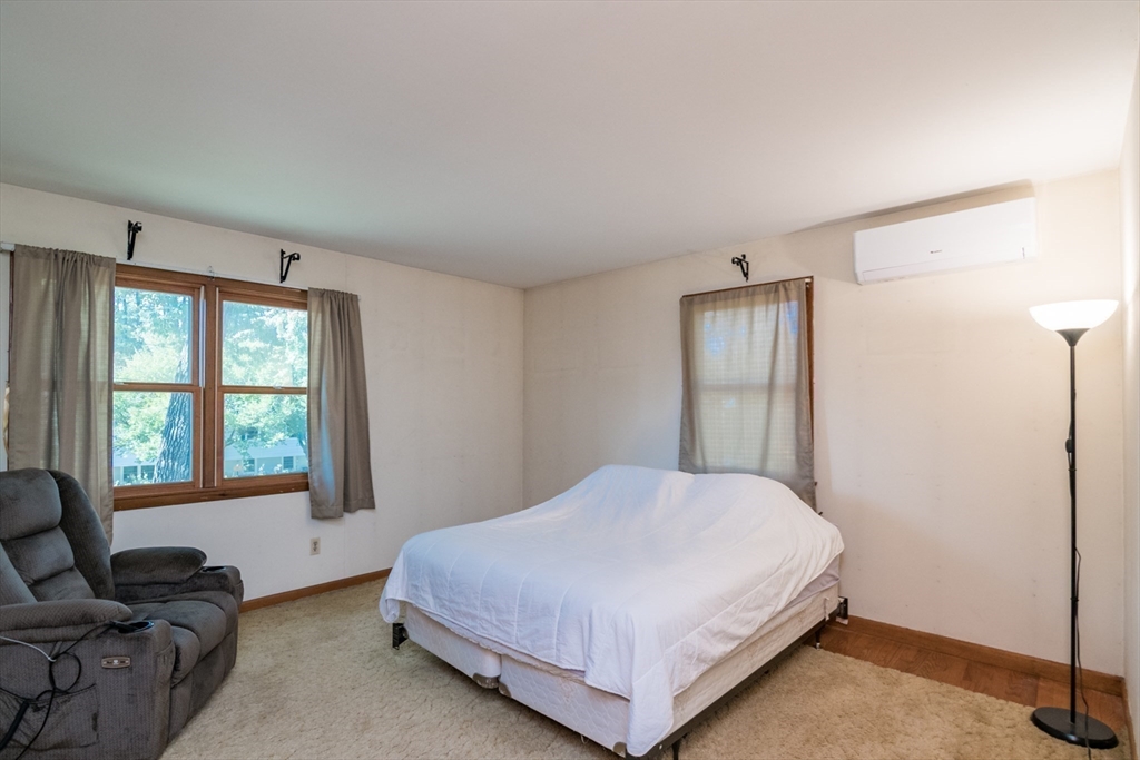 8 Sunset Drive Montague, MA 01376 - Photo 17 of 29 a bedroom with a bed flat screen tv and windows