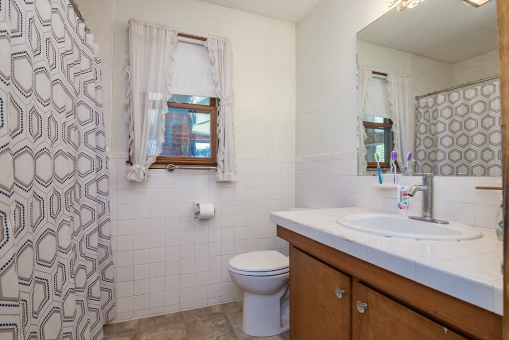8 Sunset Drive Montague, MA 01376 - Photo 25 of 29 a bathroom with a granite countertop sink toilet and mirror