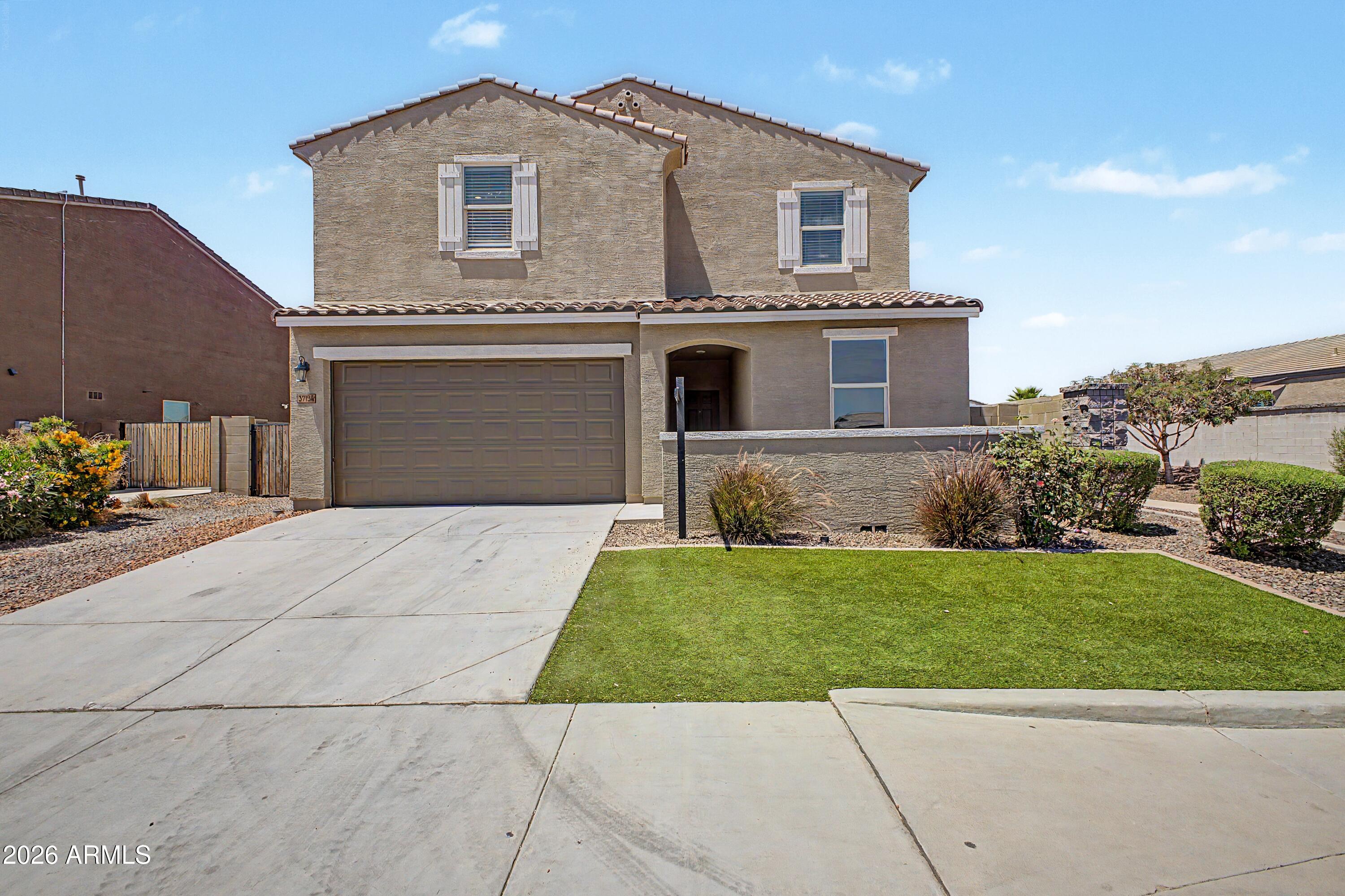a front view of a house with a yard and garage