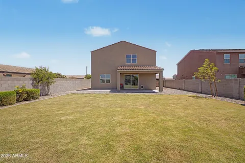 a backyard of a house with table and chairs
