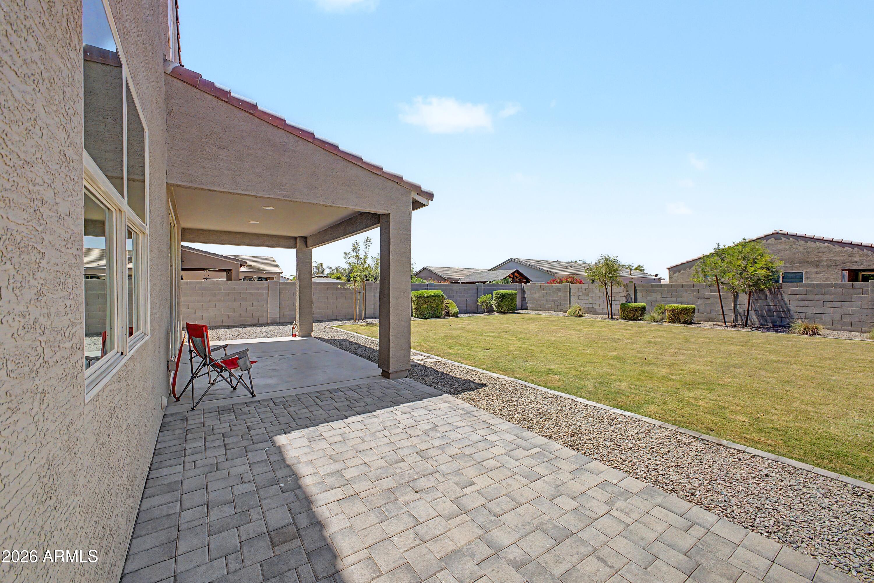 37154 North Navarra Road San Tan Valley, AZ 85140 - Photo 25 of 25 a backyard of a house with table and chairs