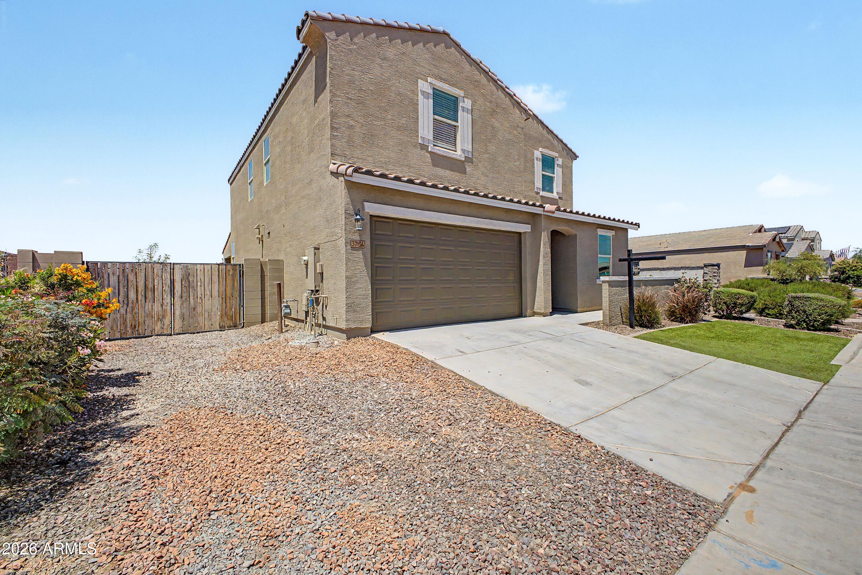 37154 North Navarra Road San Tan Valley, AZ 85140 - Photo 3 of 25 a front view of a house with a yard and garage