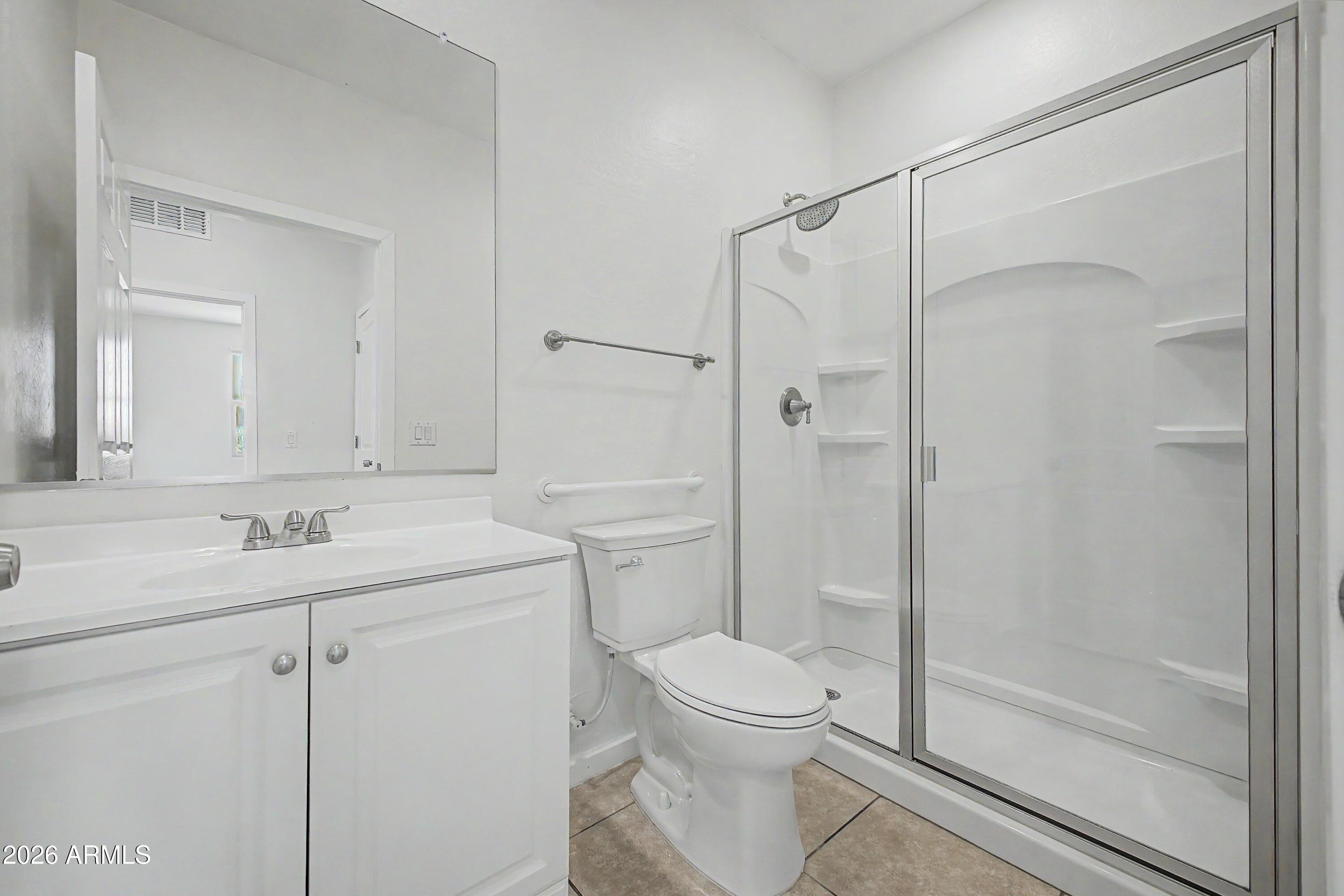 37154 North Navarra Road San Tan Valley, AZ 85140 - Photo 8 of 25 a bathroom with a shower sink vanity mirror and toilet