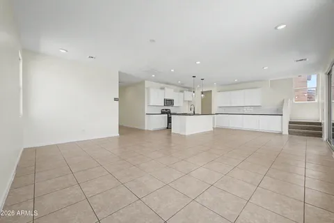 a view of a kitchen with white cabinets