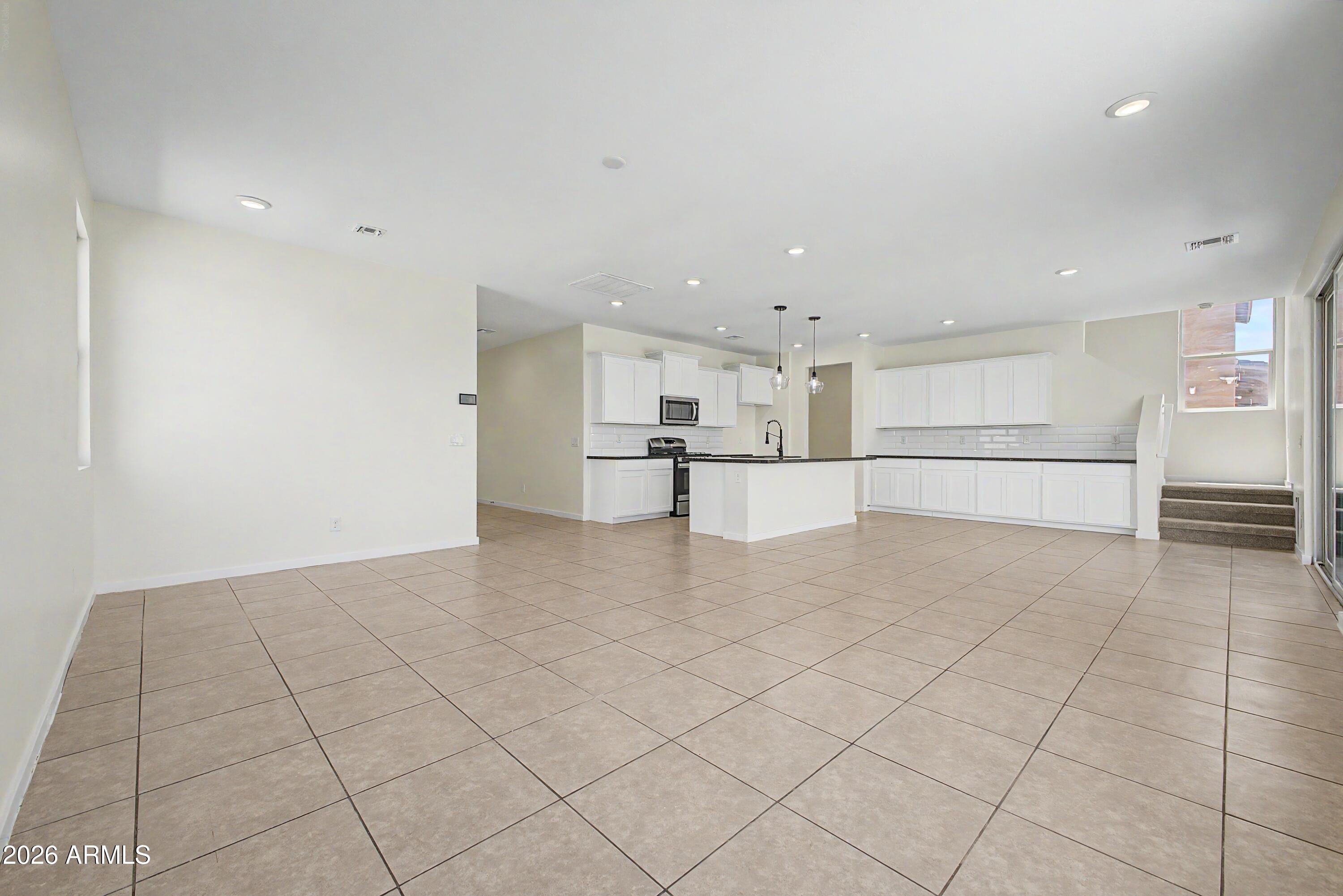 37154 North Navarra Road San Tan Valley, AZ 85140 - Photo 9 of 25 a view of a kitchen with white cabinets