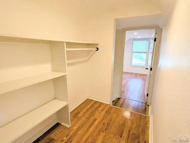 a view of a room with wooden floor
