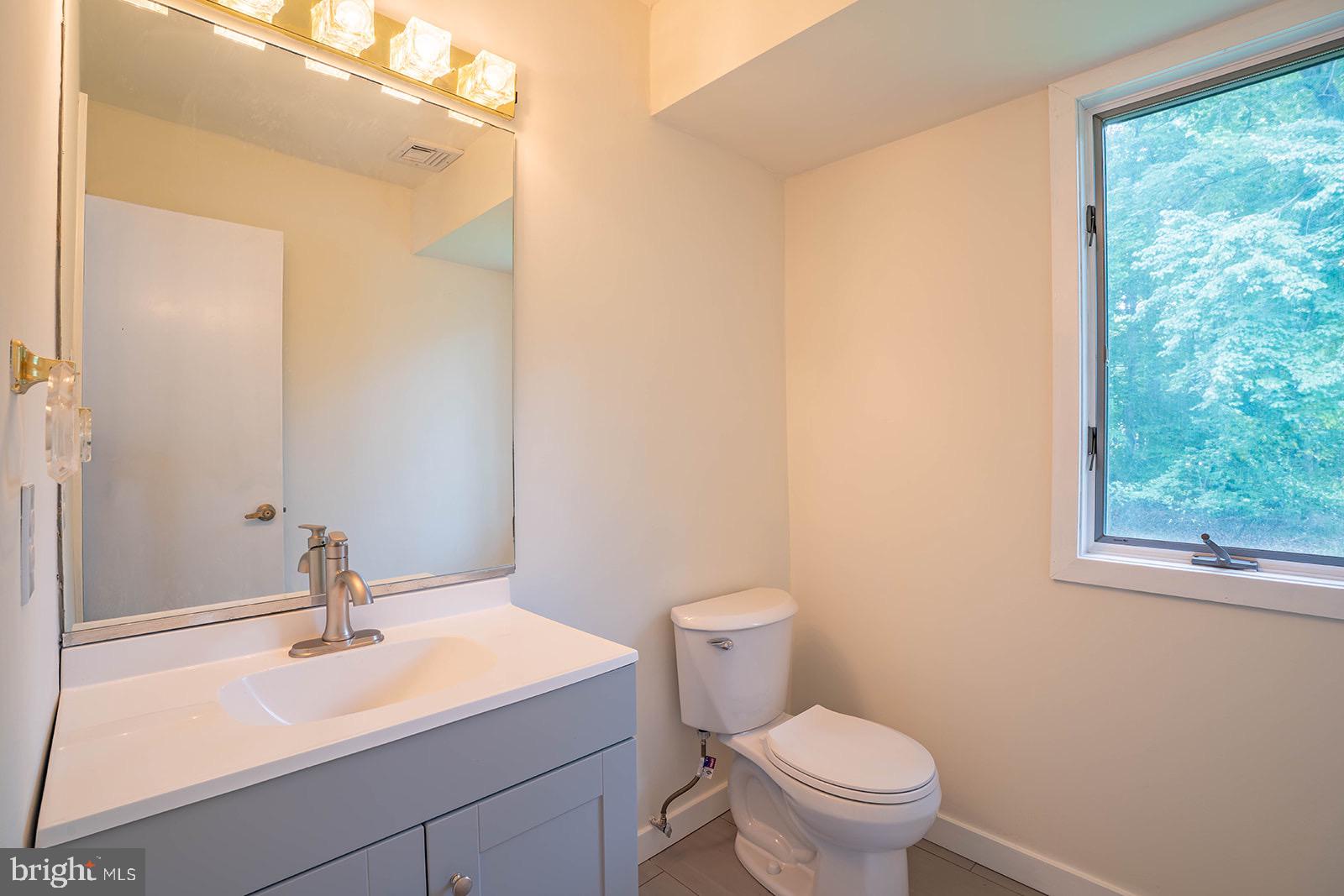 491 Kings Road Yardley, PA 19067 - Photo 25 of 52 a bathroom with a sink a toilet and a mirror