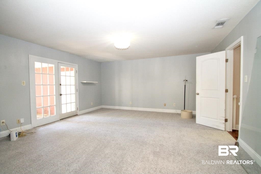 205 Montclair Loop Daphne, AL 36526 - Photo 9 of 19 Carpeted spare room with french doors