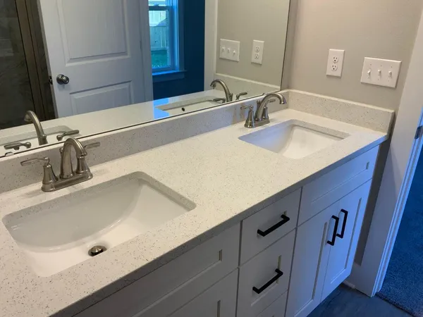 a bathroom with a double vanity sink and a mirror
