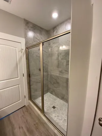 a bathroom with a glass shower door