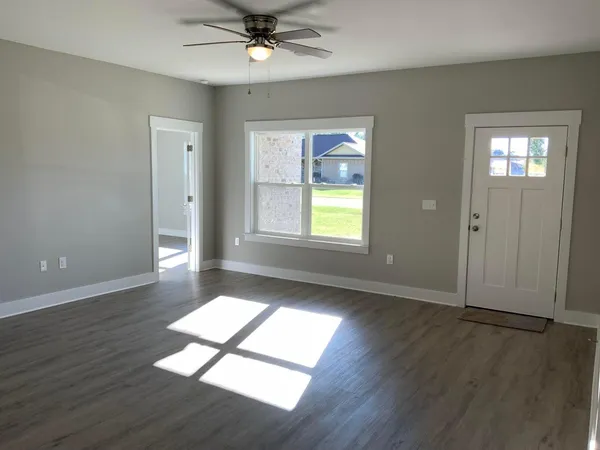 wooden floor in an empty room with a window