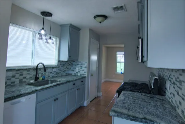 a spacious bathroom with sinks granite countertop a sink and a mirror