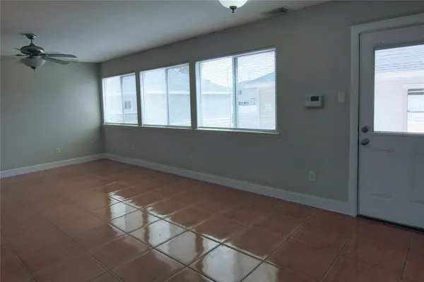 an empty room with windows and closet