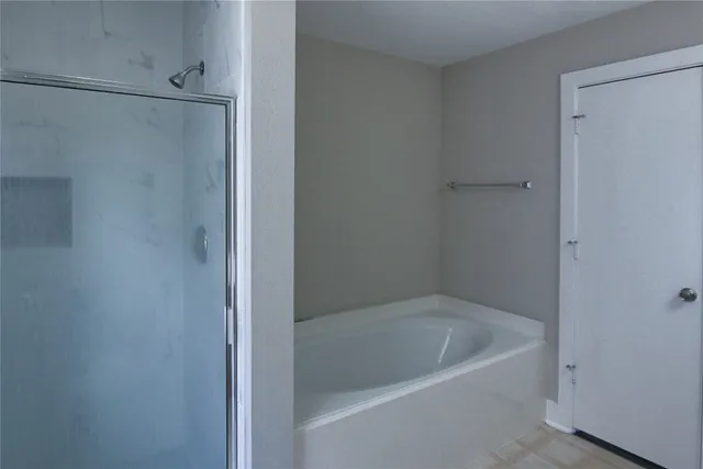 a bath tub sitting next to a shower