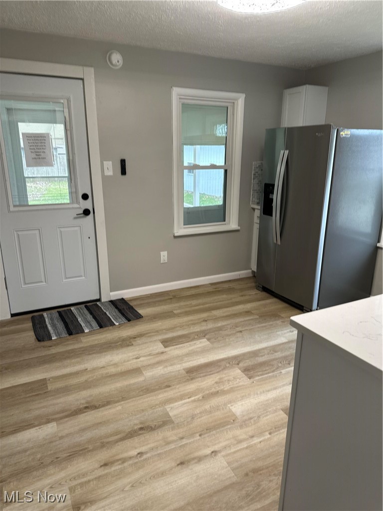 6530 Branch Road Medina, OH 44256 - Photo 3 of 35 Kitchen with a textured ceiling, light hardwood / wood-style floors, and fridge