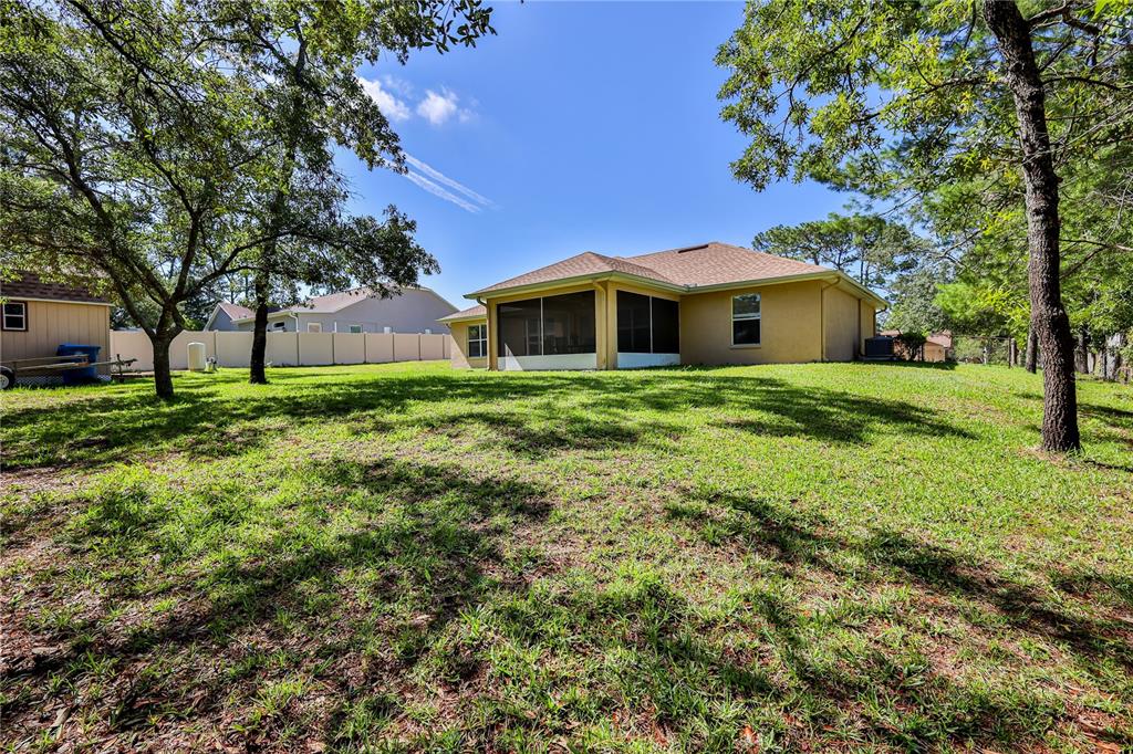 11213 Flock Avenue Weeki Wachee, FL 34613 - Photo 45 of 46 a front view of a house with a yard