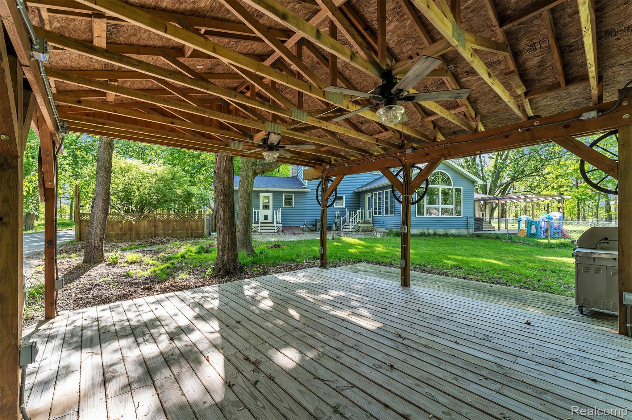 1345 Ives Road Mason, MI 48854 - Photo 68 of 92 Wooden deck featuring ceiling fan, a grill, and entry steps