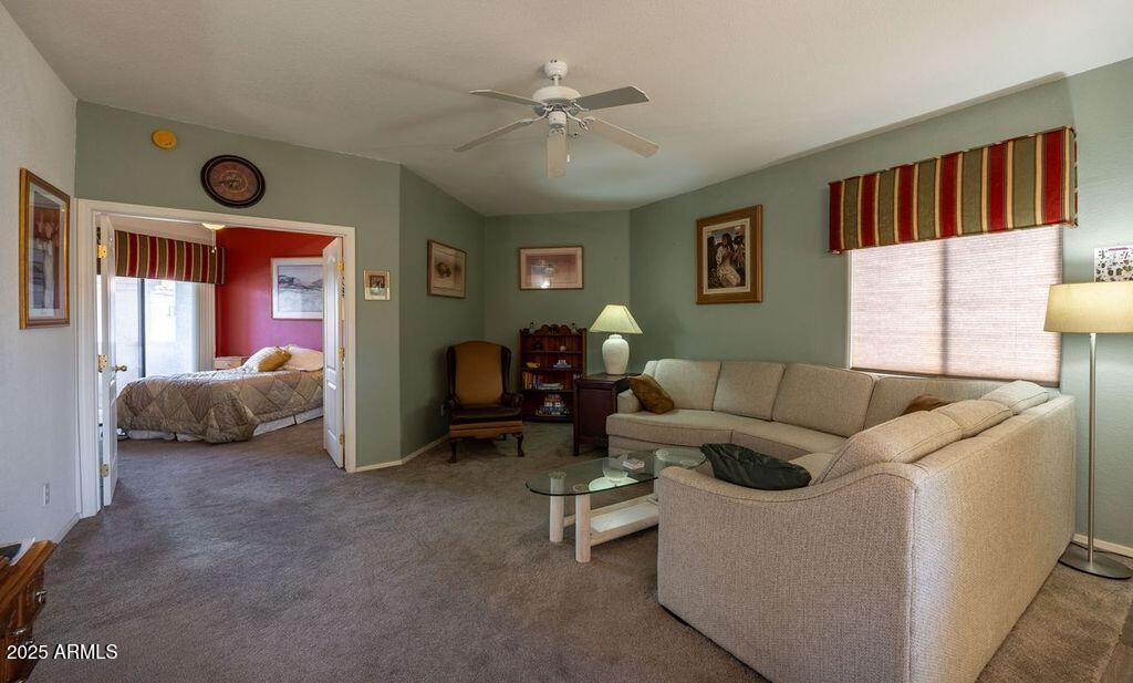 9151 West Greenway Road, Unit 273 Peoria, AZ 85381 - Photo 13 of 24 a living room with furniture and a ceiling fan