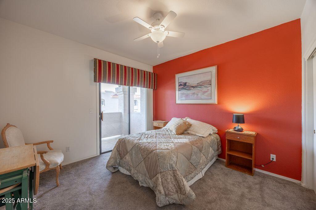 9151 West Greenway Road, Unit 273 Peoria, AZ 85381 - Photo 14 of 24 a bedroom with a bed and a chandelier