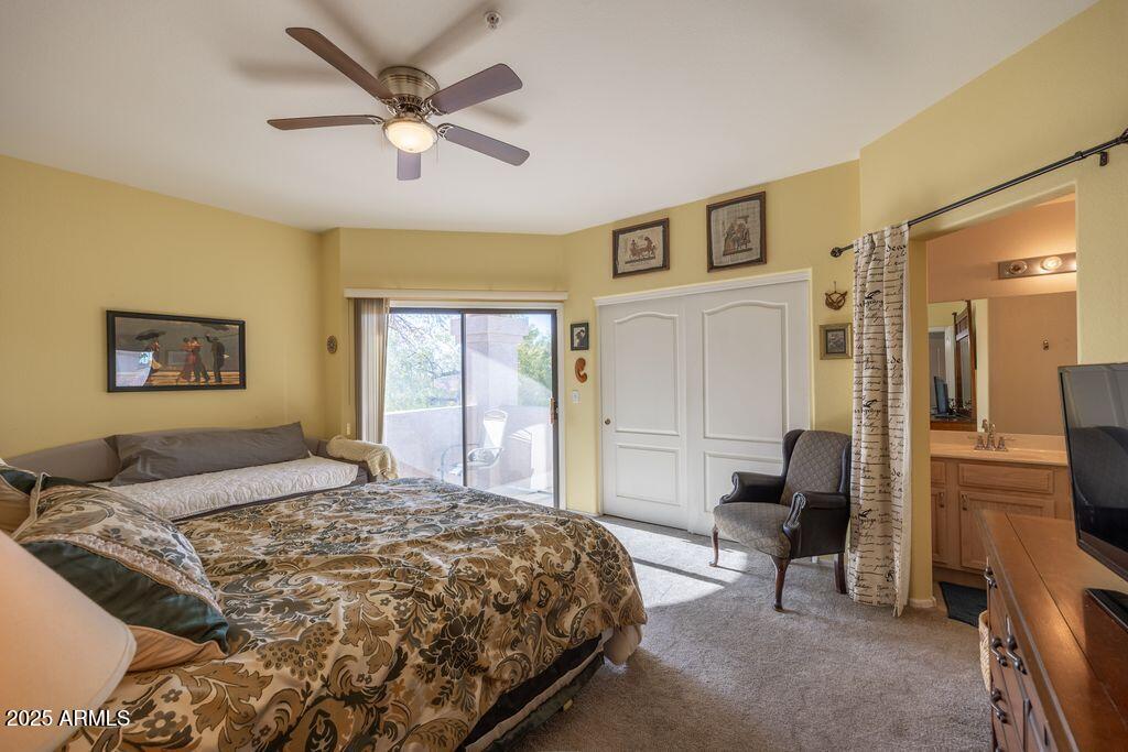 9151 West Greenway Road, Unit 273 Peoria, AZ 85381 - Photo 14 of 24 a bedroom with a bed and a large window