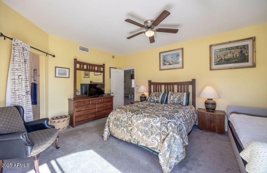 9151 West Greenway Road, Unit 273 Peoria, AZ 85381 - Photo 17 of 24 a living room with a bed furniture and a flat screen tv