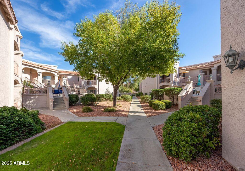 9151 West Greenway Road, Unit 273 Peoria, AZ 85381 - Photo 22 of 24 a view of a backyard with sitting area