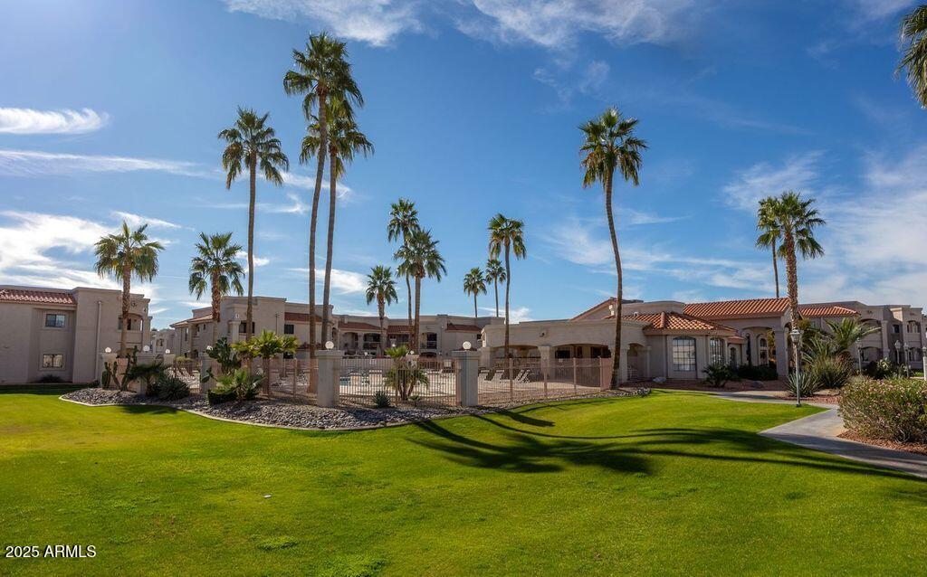 9151 West Greenway Road, Unit 273 Peoria, AZ 85381 - Photo 23 of 24 a view of a swimming pool with a garden and plants