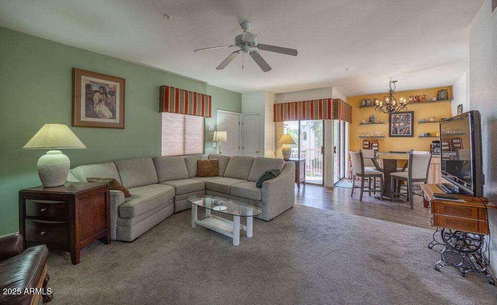 9151 West Greenway Road, Unit 273 Peoria, AZ 85381 - Photo 4 of 24 a living room with furniture and a flat screen tv