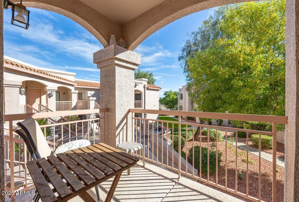 9151 West Greenway Road, Unit 273 Peoria, AZ 85381 - Photo 5 of 24 a view of a balcony with wooden floor