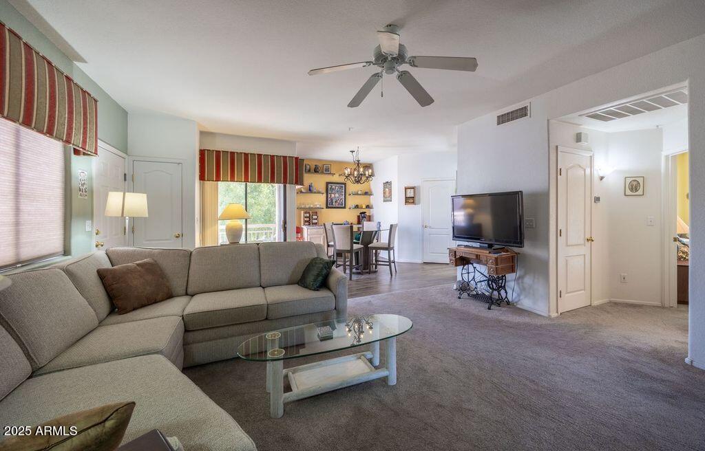 9151 West Greenway Road, Unit 273 Peoria, AZ 85381 - Photo 5 of 24 a living room with furniture and a flat screen tv