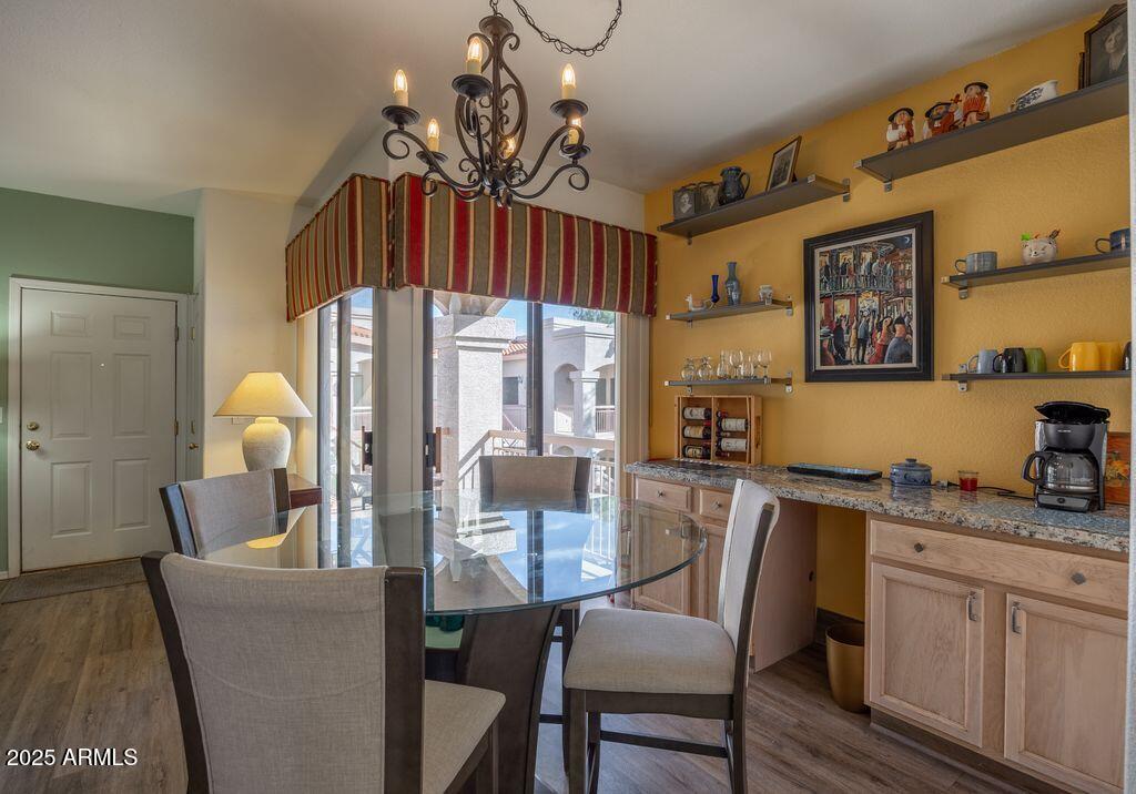 9151 West Greenway Road, Unit 273 Peoria, AZ 85381 - Photo 6 of 24 a dining room with furniture a chandelier and window