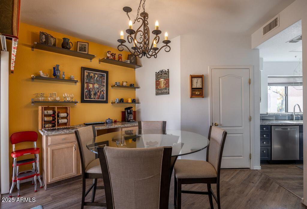 9151 West Greenway Road, Unit 273 Peoria, AZ 85381 - Photo 7 of 24 a view of a dining room with furniture and a chandelier