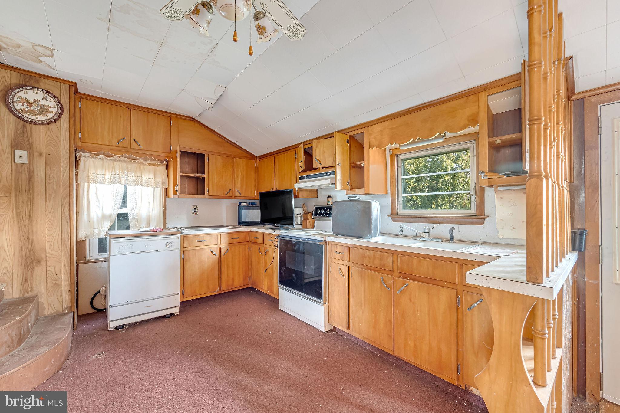 321 Jones Island Road Cedarville, NJ 08311 - Photo 24 of 39 a kitchen with a stove a sink and a refrigerator