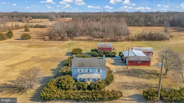 an aerial view of residential houses with outdoor space and swimming pool