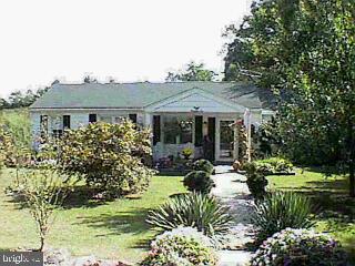 1910 Temple School Road Dover, PA 17315 - Photo 1 of 1 a front view of a house with a garden