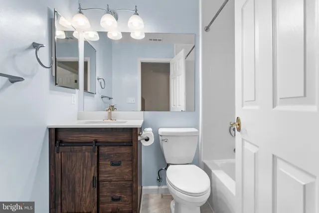 a bathroom with a toilet a sink and a mirror