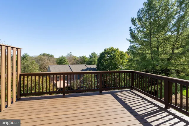 a view of balcony with wooden floor and fence