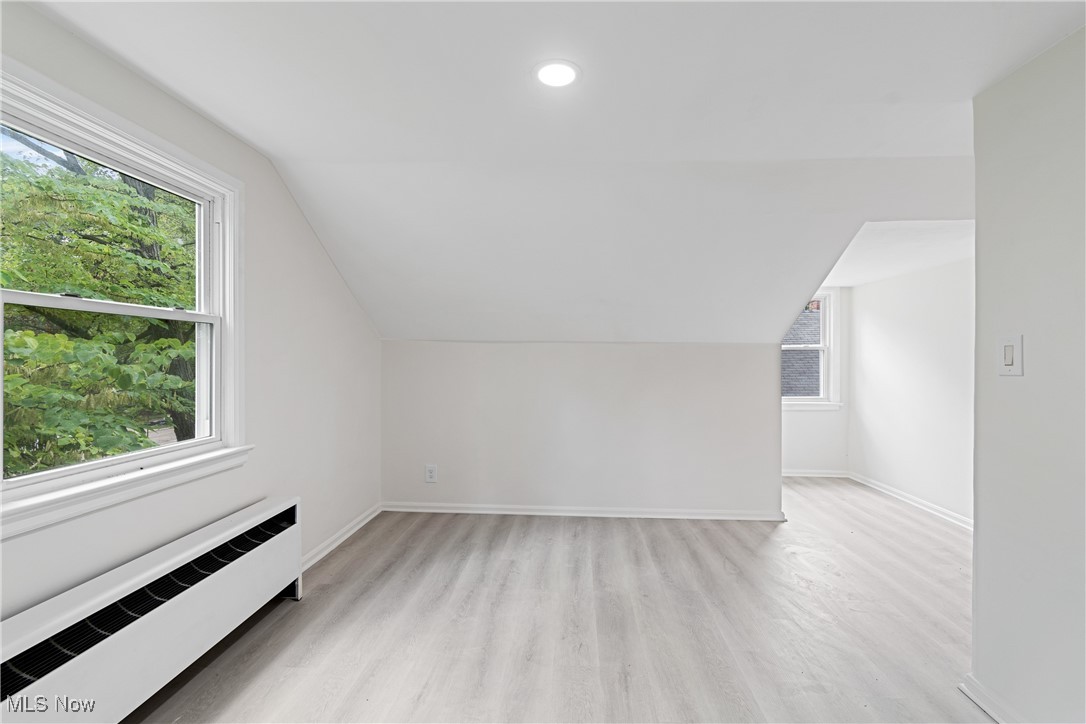 1057 Renfield Road Cleveland Heights, OH 44121 - Photo 25 of 30 Additional living space with radiator, a wealth of natural light, and light hardwood / wood-style flooring