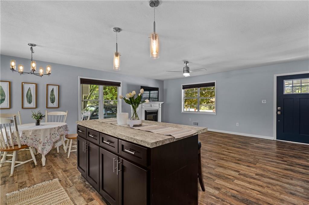 3990 Pine Mountain Road Northwest Kennesaw, GA 30152 - Photo 12 of 32 a view of a kitchen counter space dining table and wooden floor