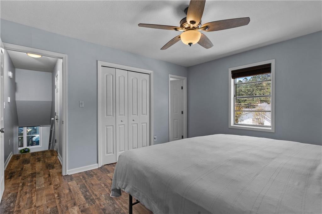3990 Pine Mountain Road Northwest Kennesaw, GA 30152 - Photo 17 of 32 a bedroom with a bed and a chandelier