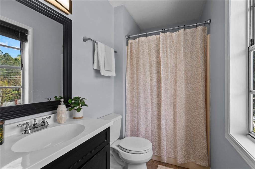 3990 Pine Mountain Road Northwest Kennesaw, GA 30152 - Photo 18 of 32 a bathroom with a sink a toilet and a mirror