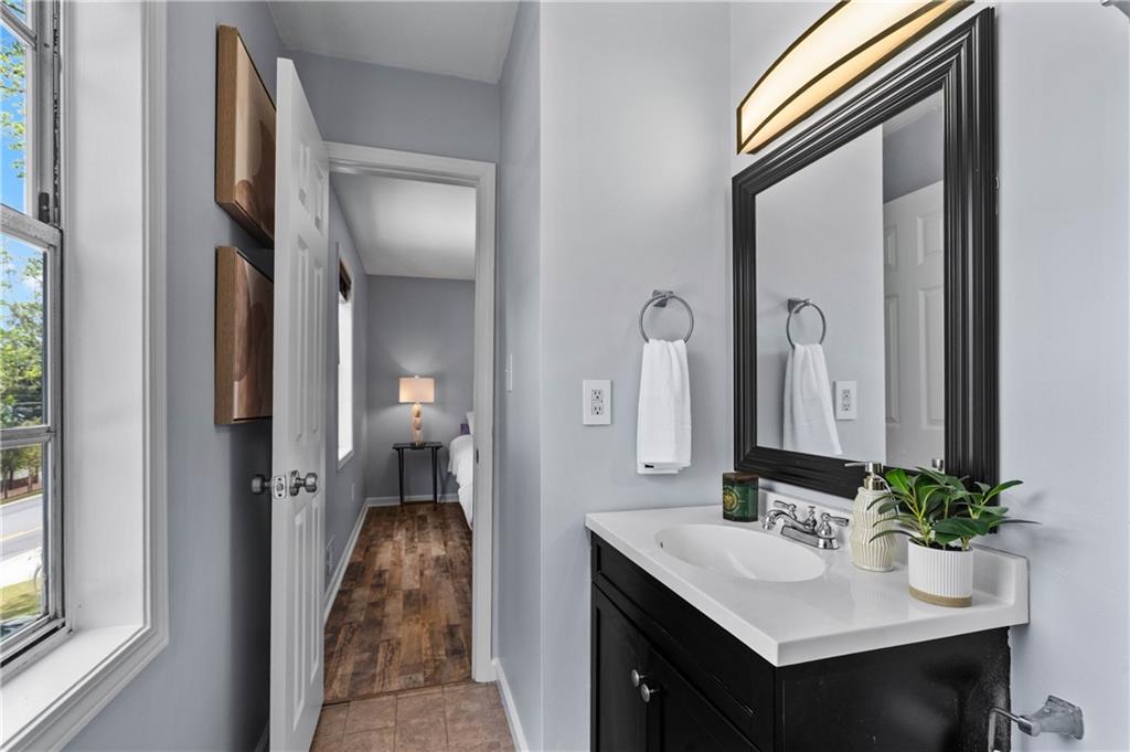3990 Pine Mountain Road Northwest Kennesaw, GA 30152 - Photo 19 of 32 a en suite bathroom with a sink and a mirror