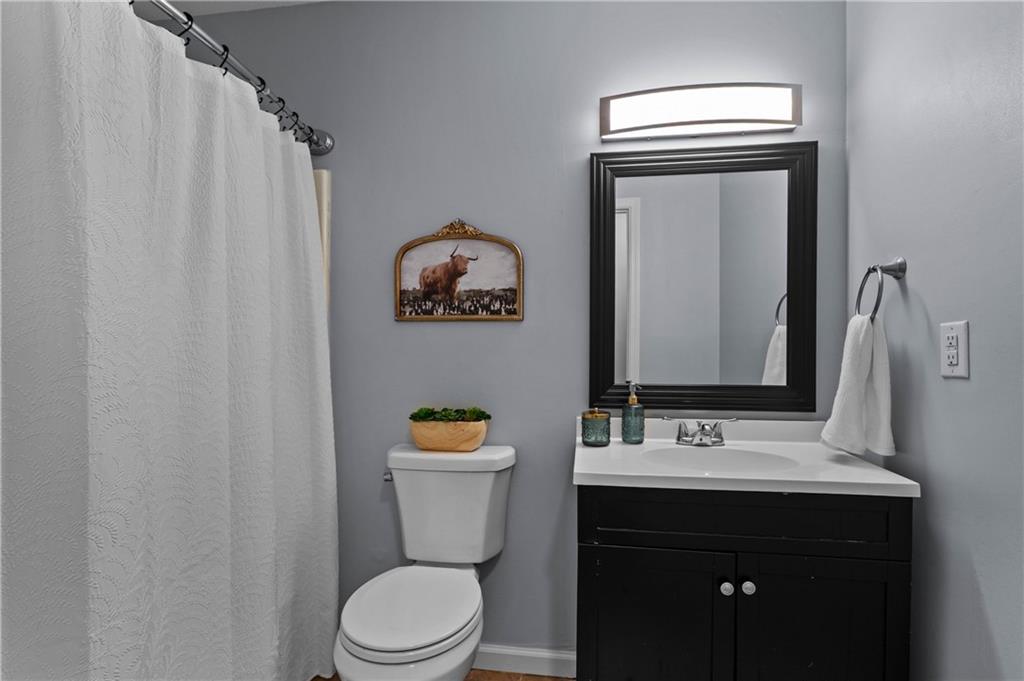 3990 Pine Mountain Road Northwest Kennesaw, GA 30152 - Photo 21 of 32 a bathroom with a toilet sink and mirror